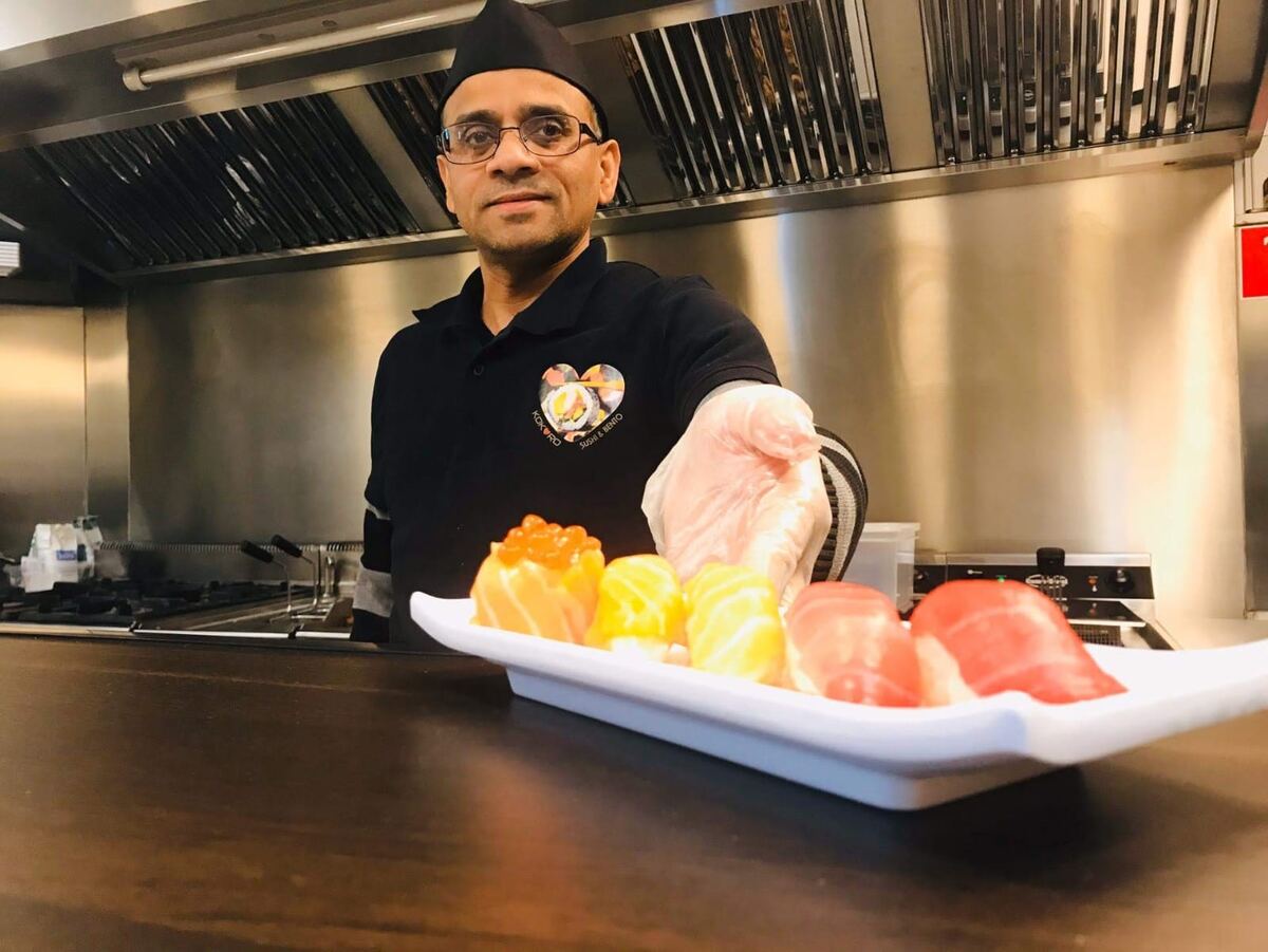 Chef at Kokoro Sushi Mol presenting fresh sushi