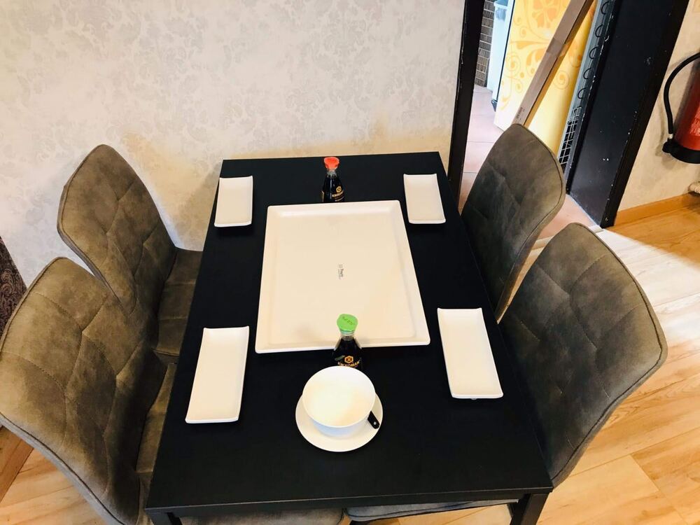 Dining table set with plates and soy sauce at Kokoro